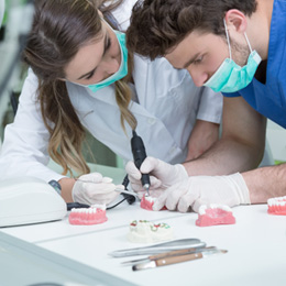 Lab workers creating a denture