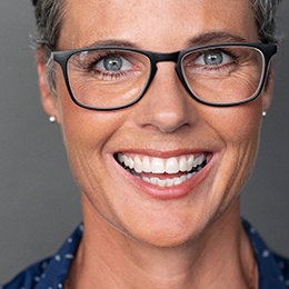 woman with glasses smiling 
